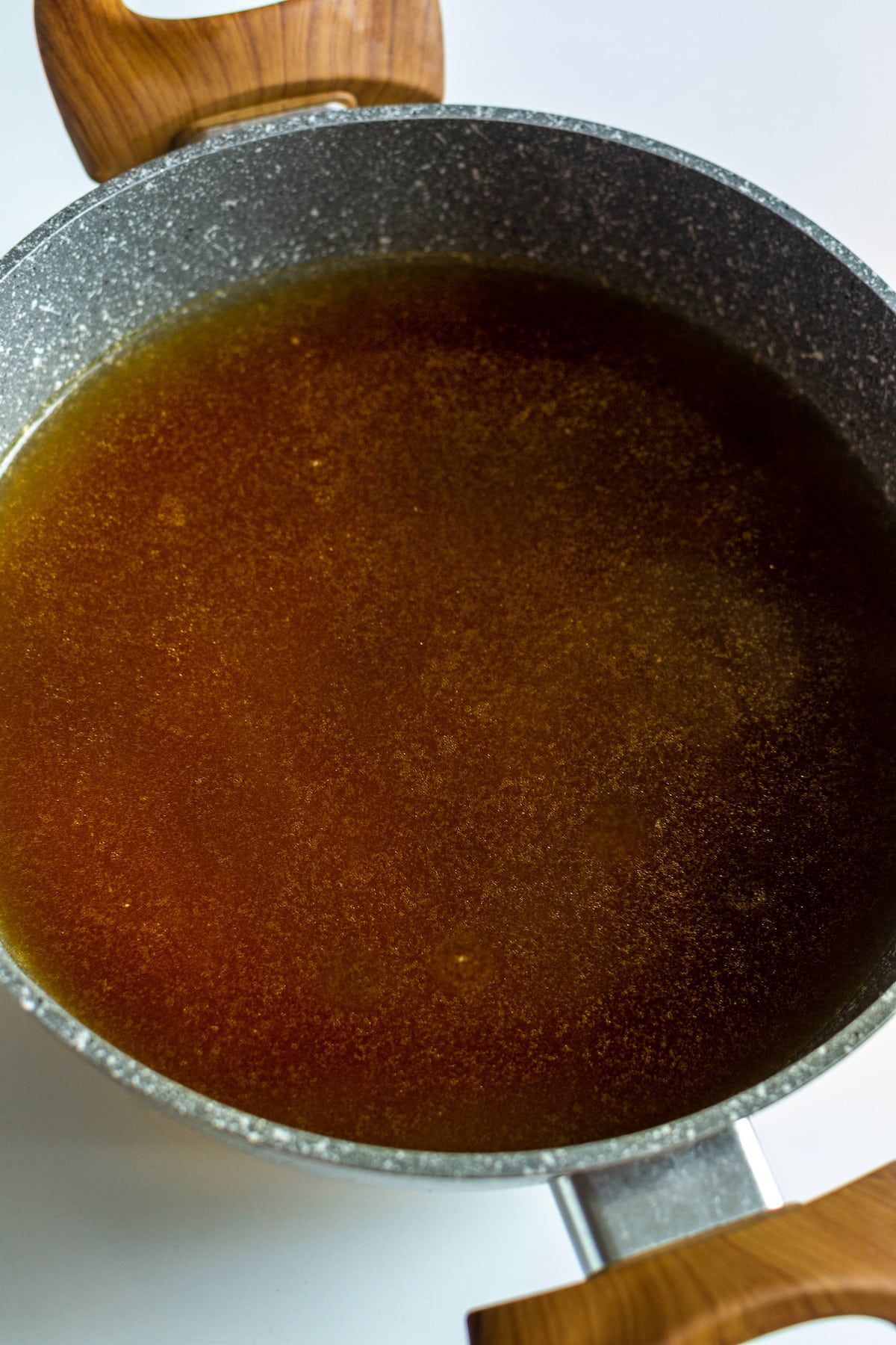 Sauce pan with clear vegetable broth.