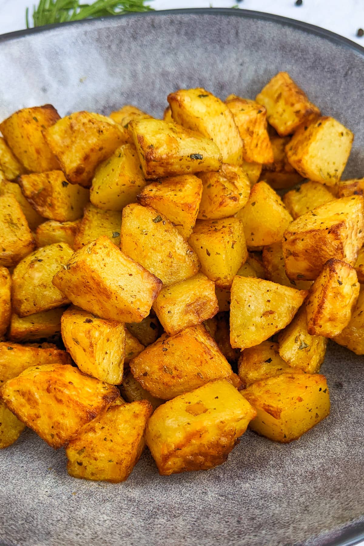 A plate with diced paprika potatoes roasted in air fryer.