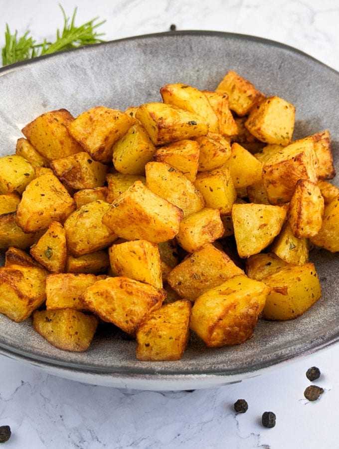 Close look of diced potatoes with paprika cooked in air fryer.