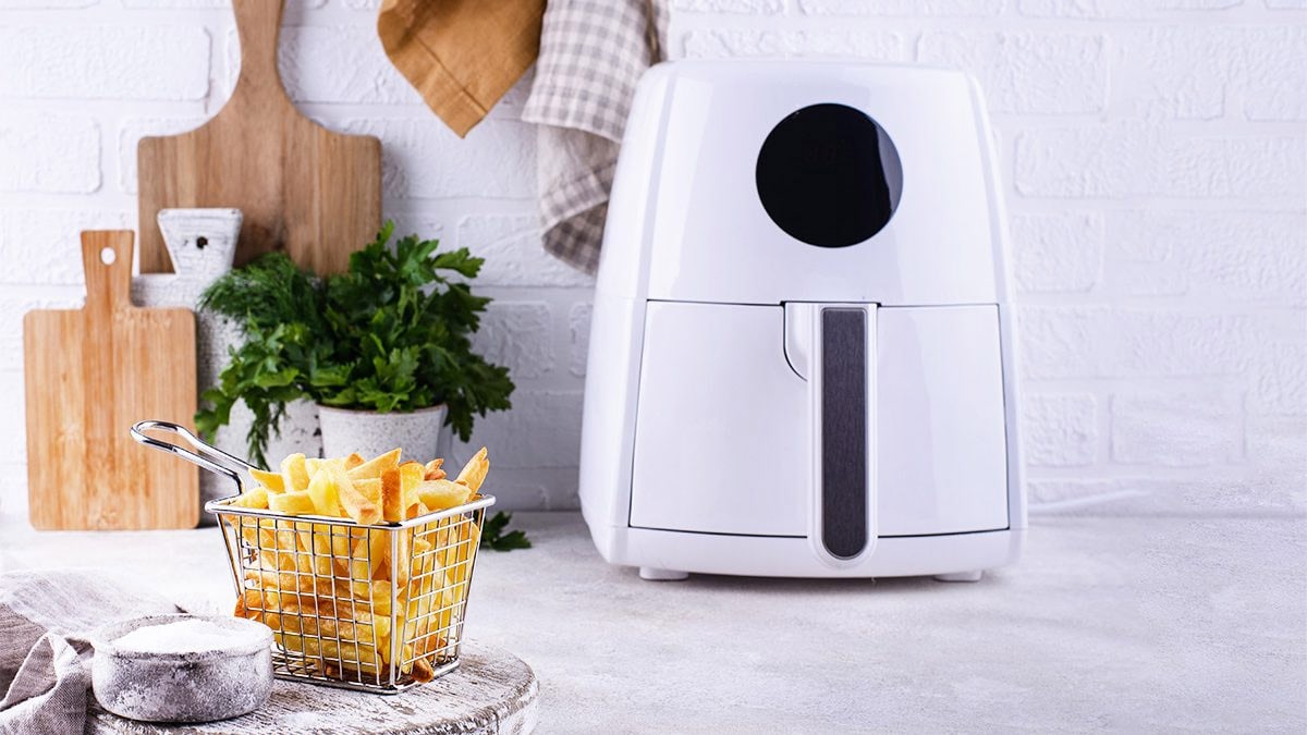 French fries cooked in a white digital air fryer.
