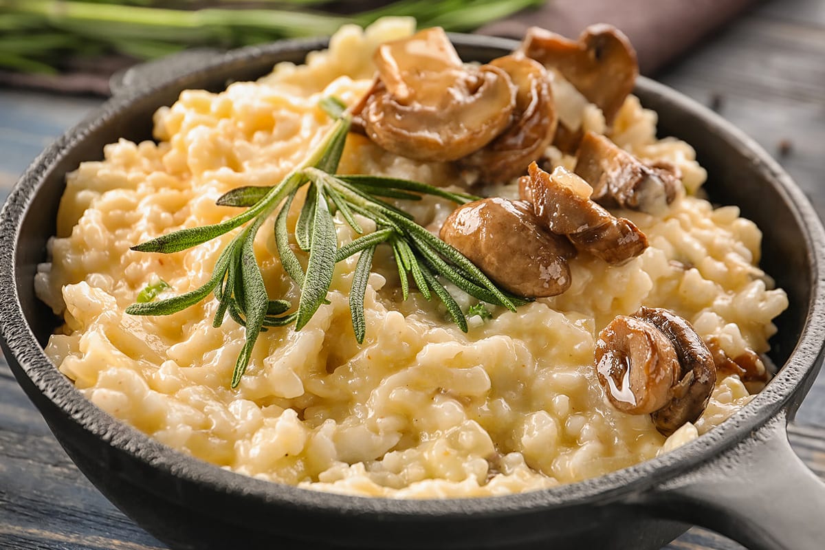 Close view of a plate with creamy risotto with mushrooms.