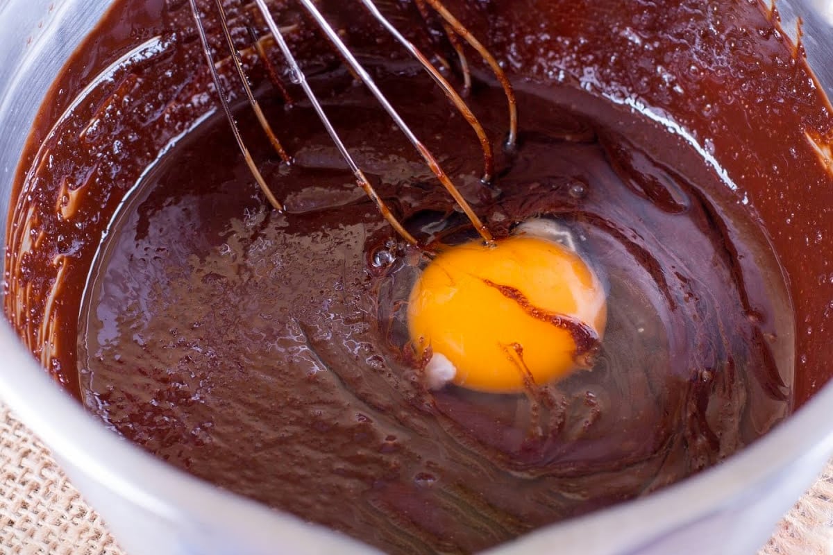 Close view of mixing an egg in a brownie mix.