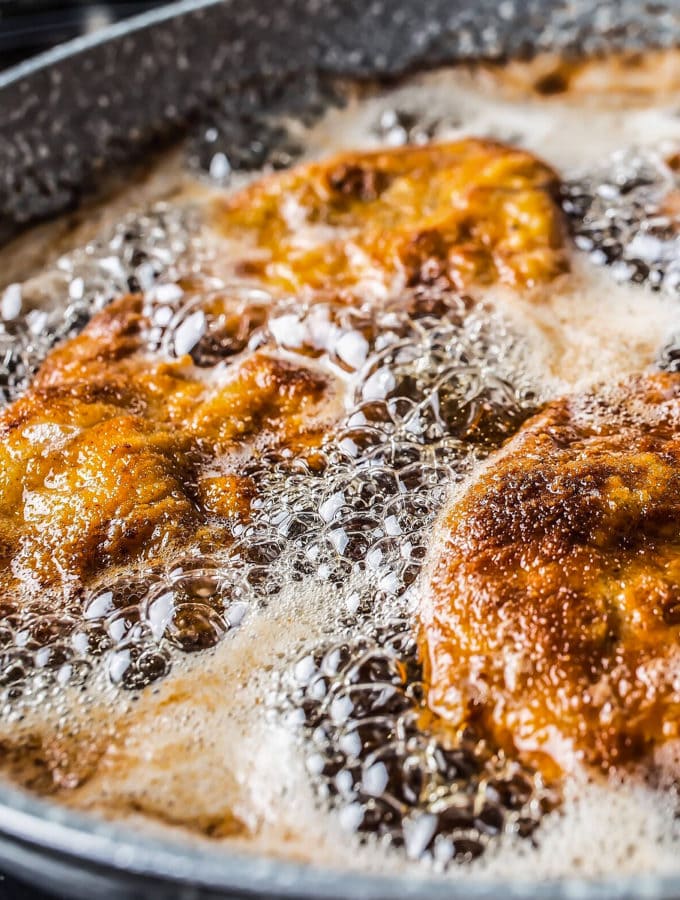 Close look for frying schnitzels in a pan.