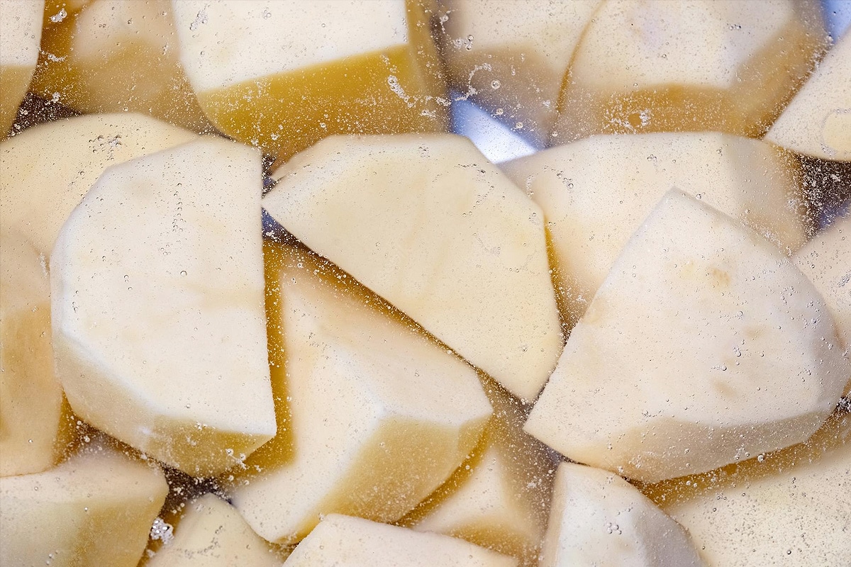 Close look of soaked potatoes in water.