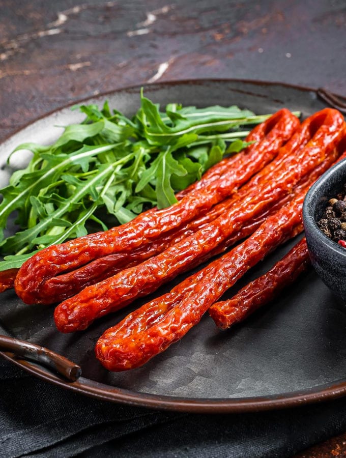 Kabana sausages with black pepper and rucola.