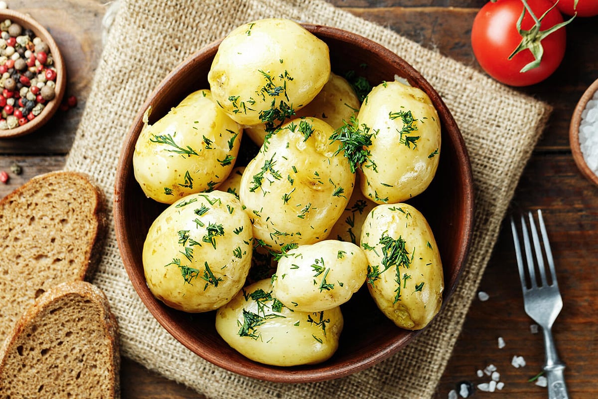 Top view of boiled potatoes with chopped dill.