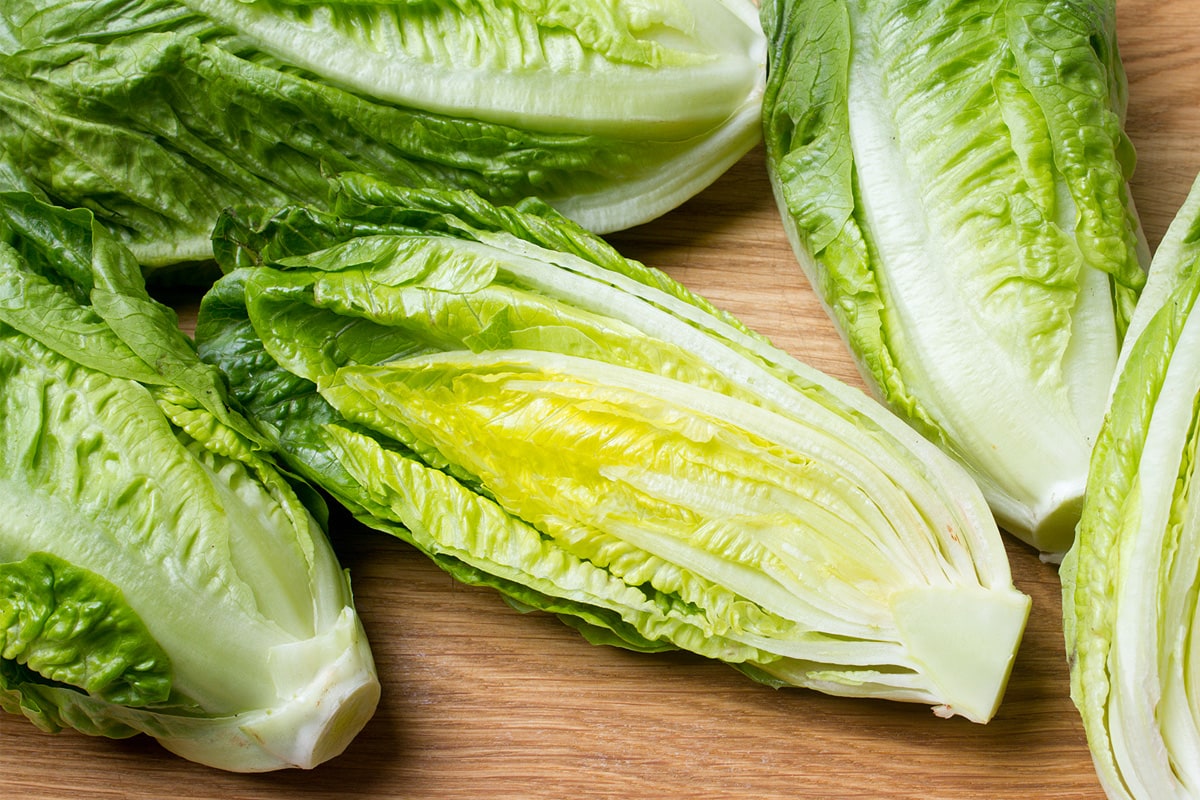 Close view of romaine lettuce on a wooden table.
