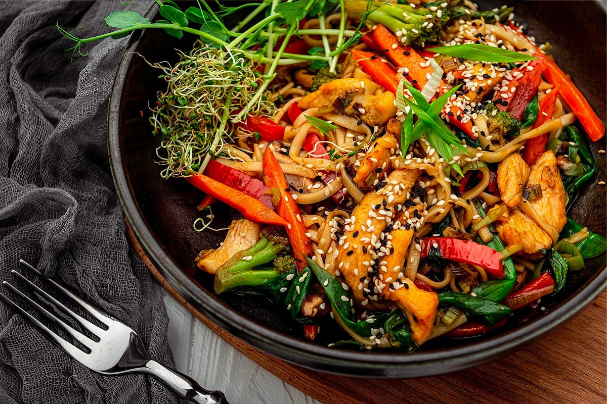 Close look of stir fry vegetables with chicken and sesame seeds.