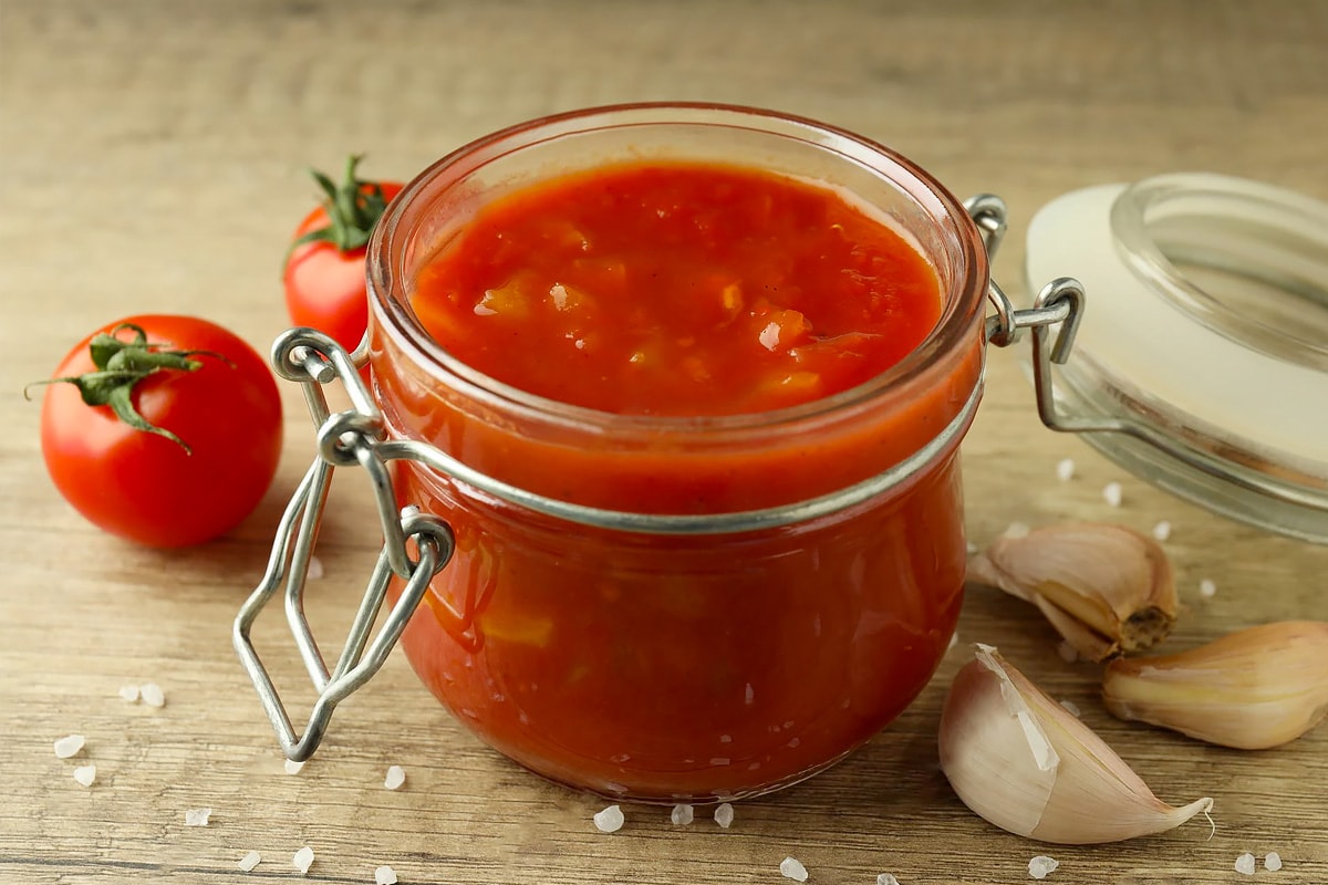 Close view of a jar with homemade tomato sauce.