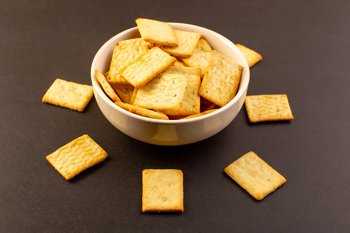 Close view of a white plate full with crackers.