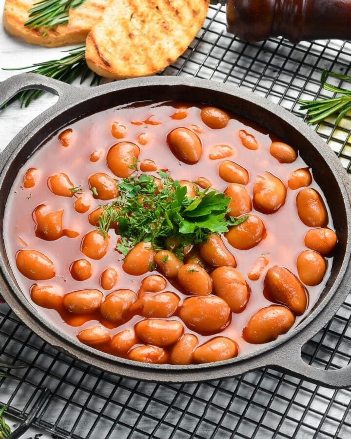 Cooked pinto beans in a metal plate.