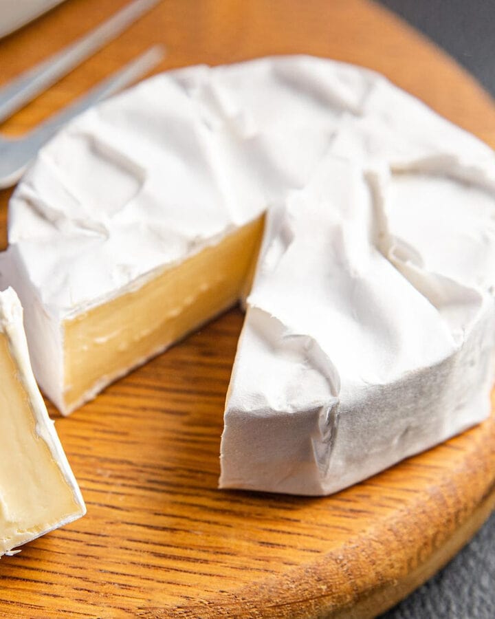 Camembert cheese on a wooden board.
