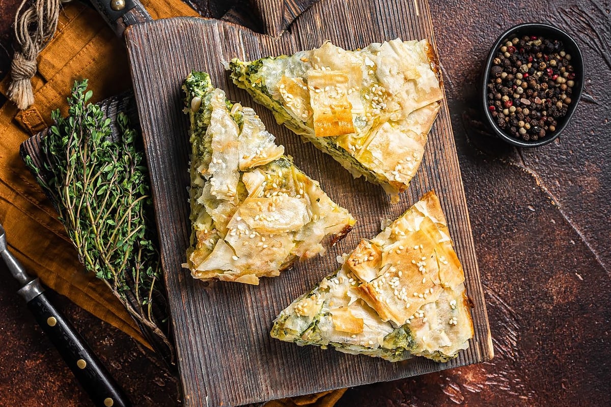 Top view of spanakopita on a wooden board.