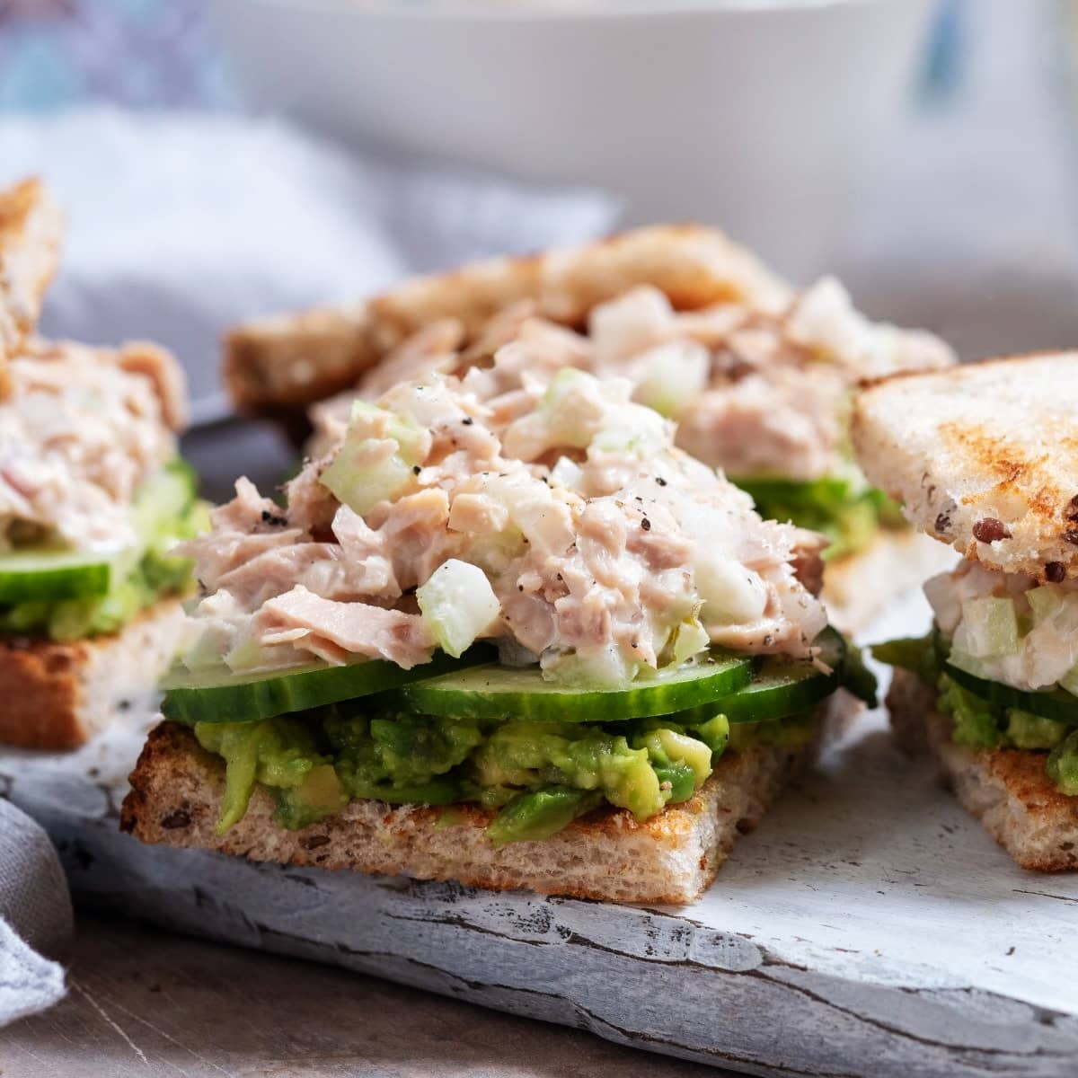 Close look of sandwiches with cucumbers and ham salad.