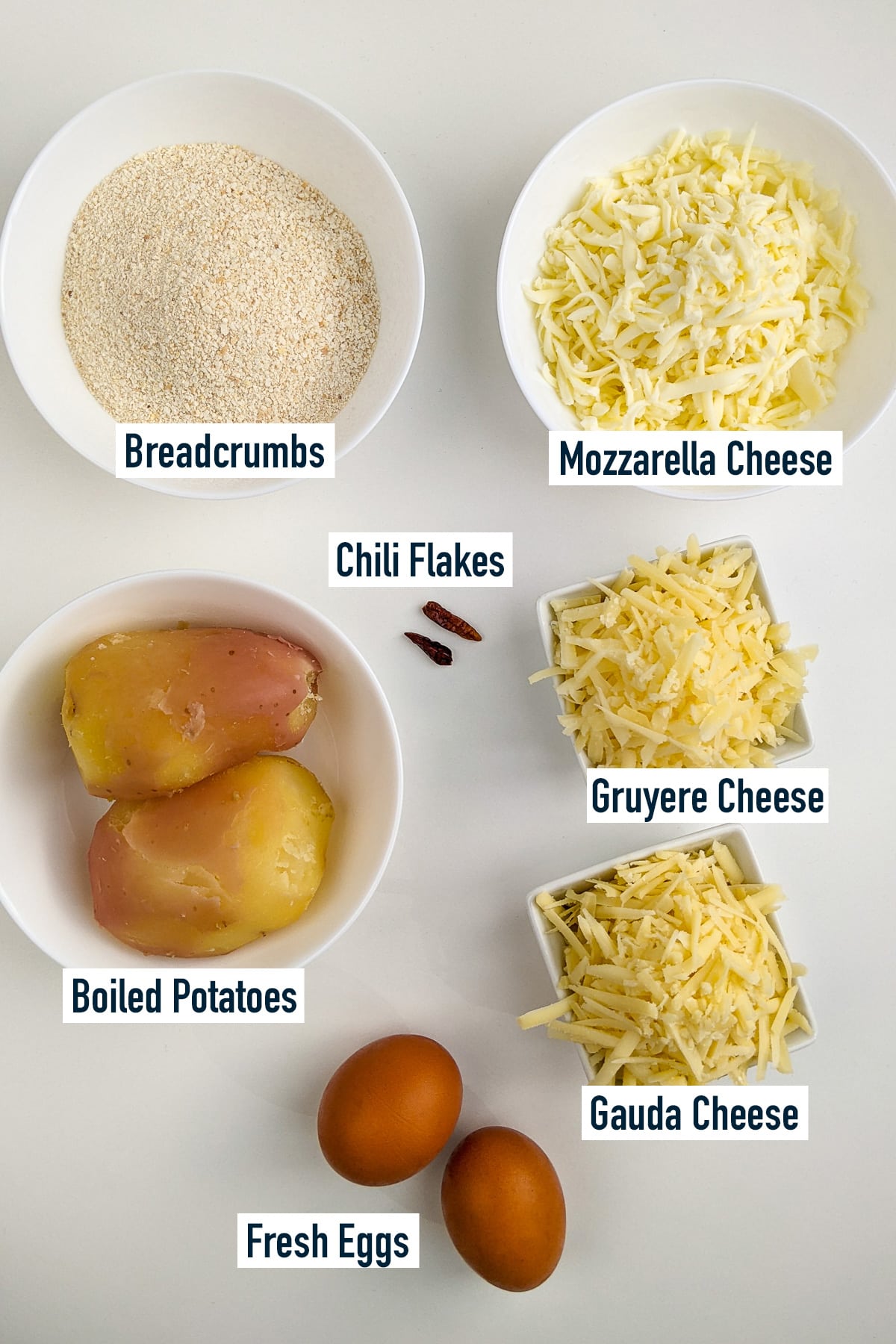 Top view of different white plates with ingredients for chili cheese nuggets.