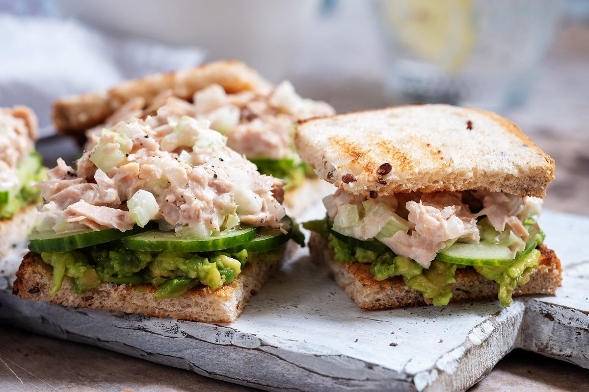 Close view of sandwiches with ham salad with cucumbers and avocado.