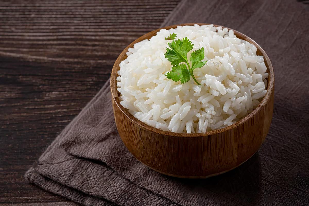 Top view of a wooden plate with steamed rice.