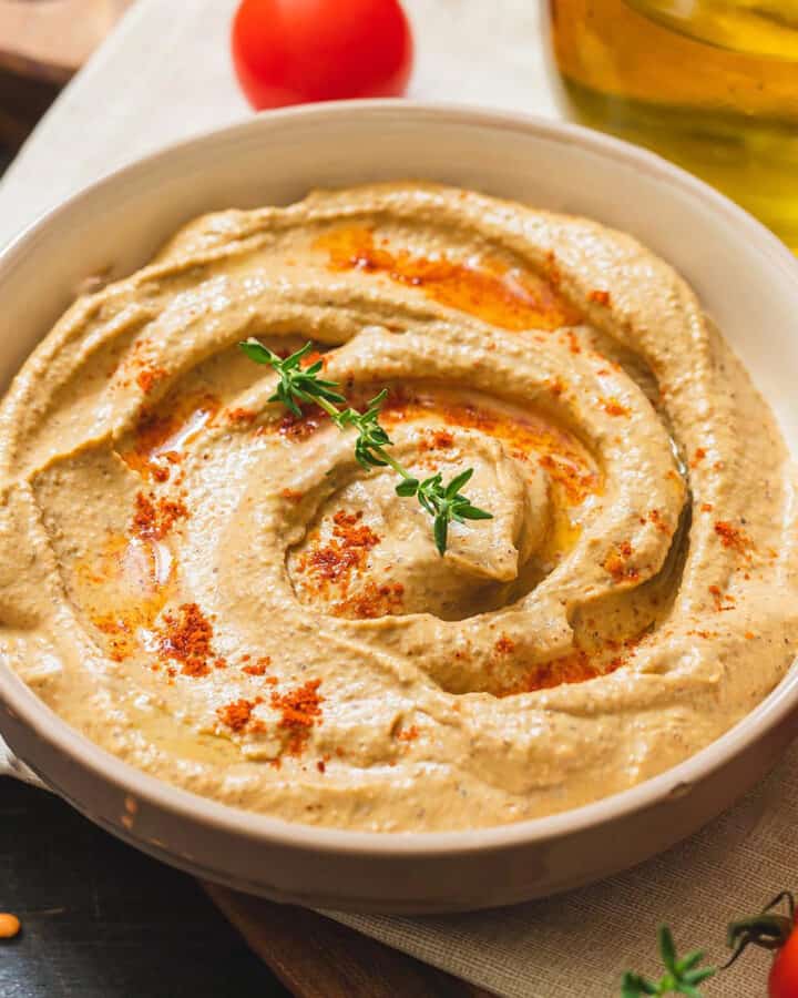 Top view of hummus with paprika and oil.