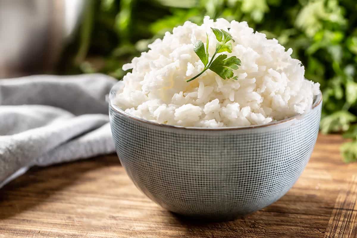 Close look of steamed white rice with a parsley steam.