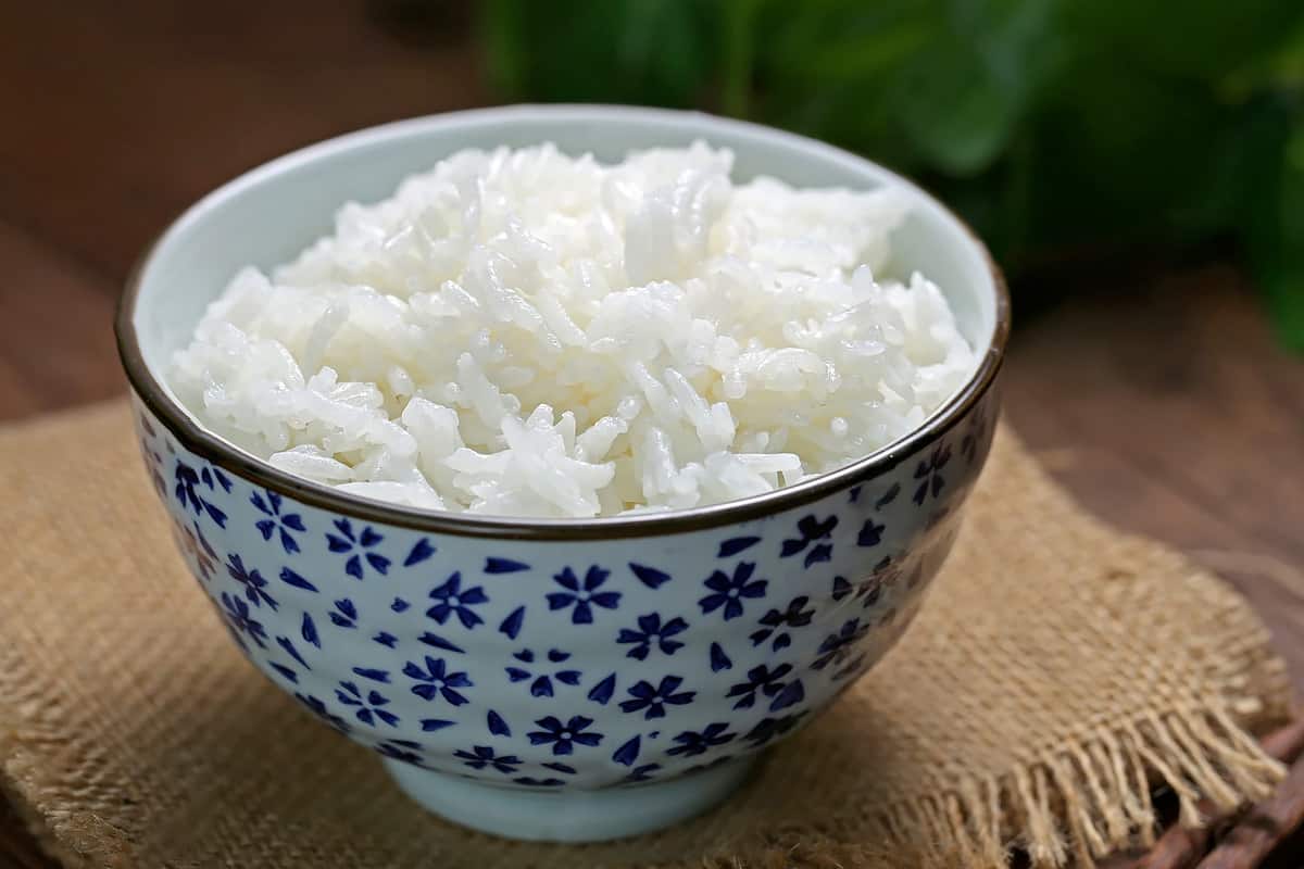 Close view of steamed rice on a rustic table.