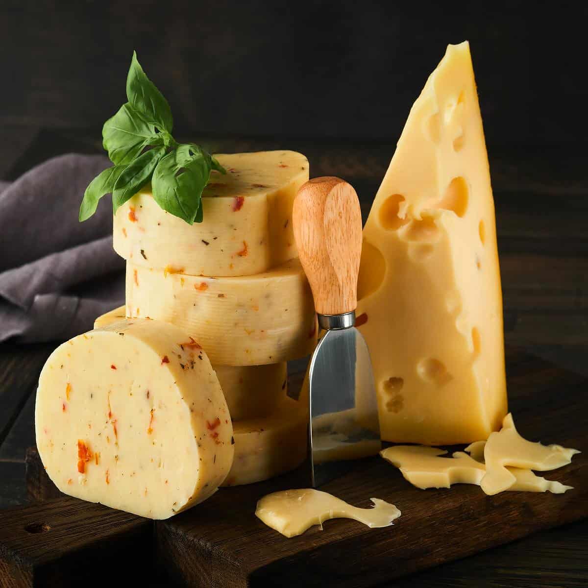 Different type of cheeses on a dark background.