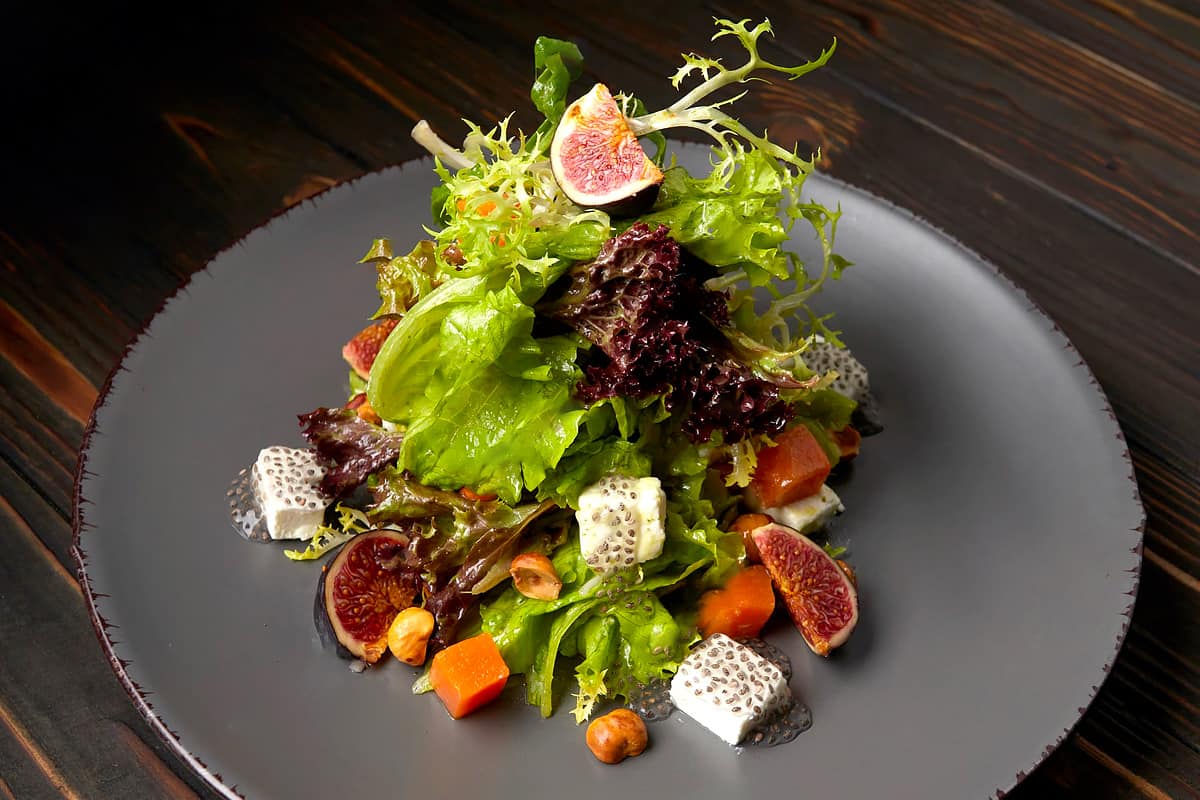 Restaurant-style salad on a gray plate.