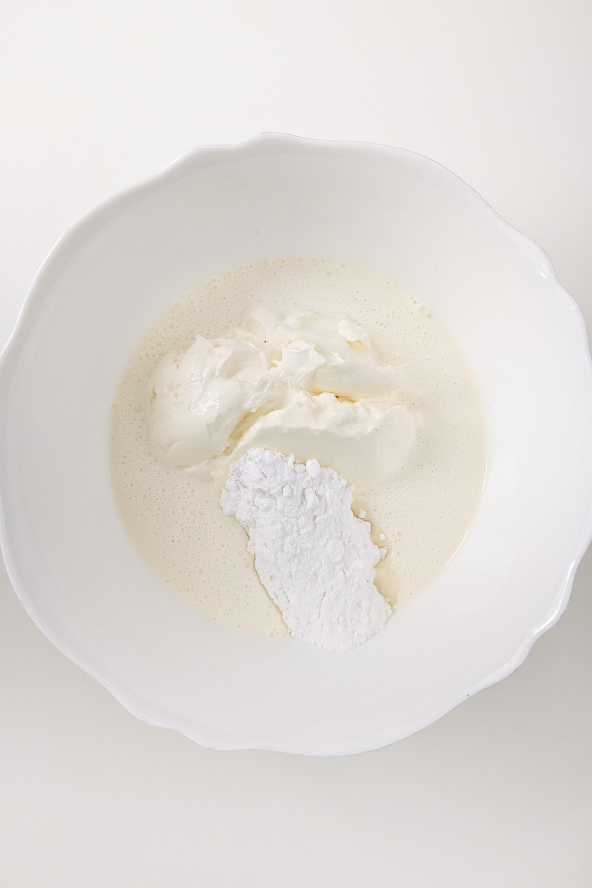 White plate with yogurt, cream cheese and flour.