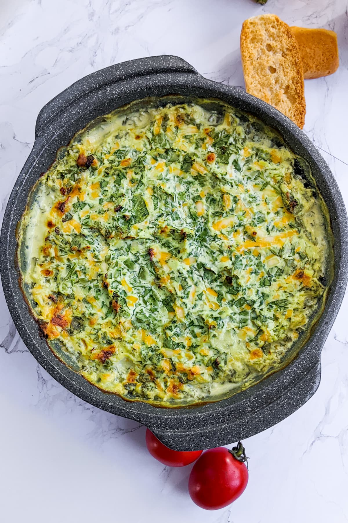 Top view of spinach dip on a white background.