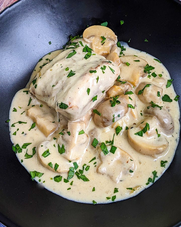 Top view of creamy turkey fricassee sprinkled with chop parsley.