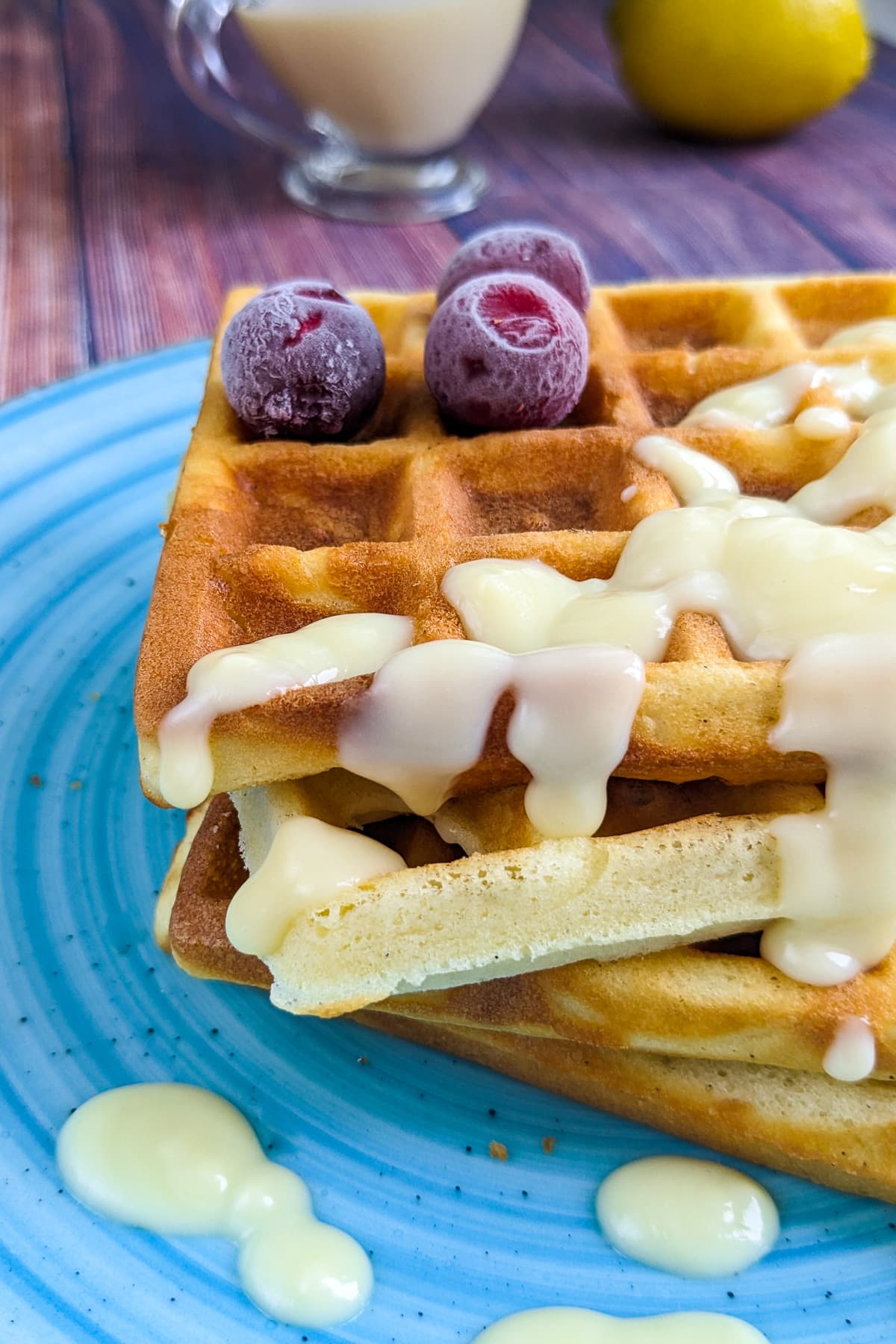Close look of homemade waffles with white waffle sauce.