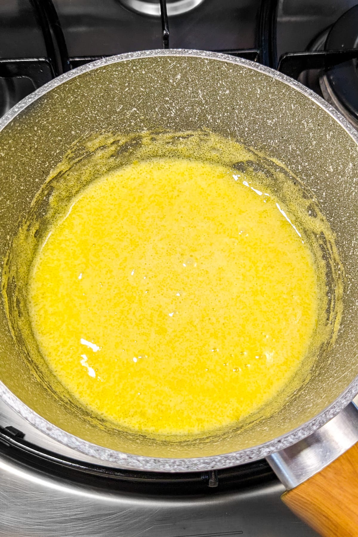 Mixed sugar with two eggs in a saucepan.