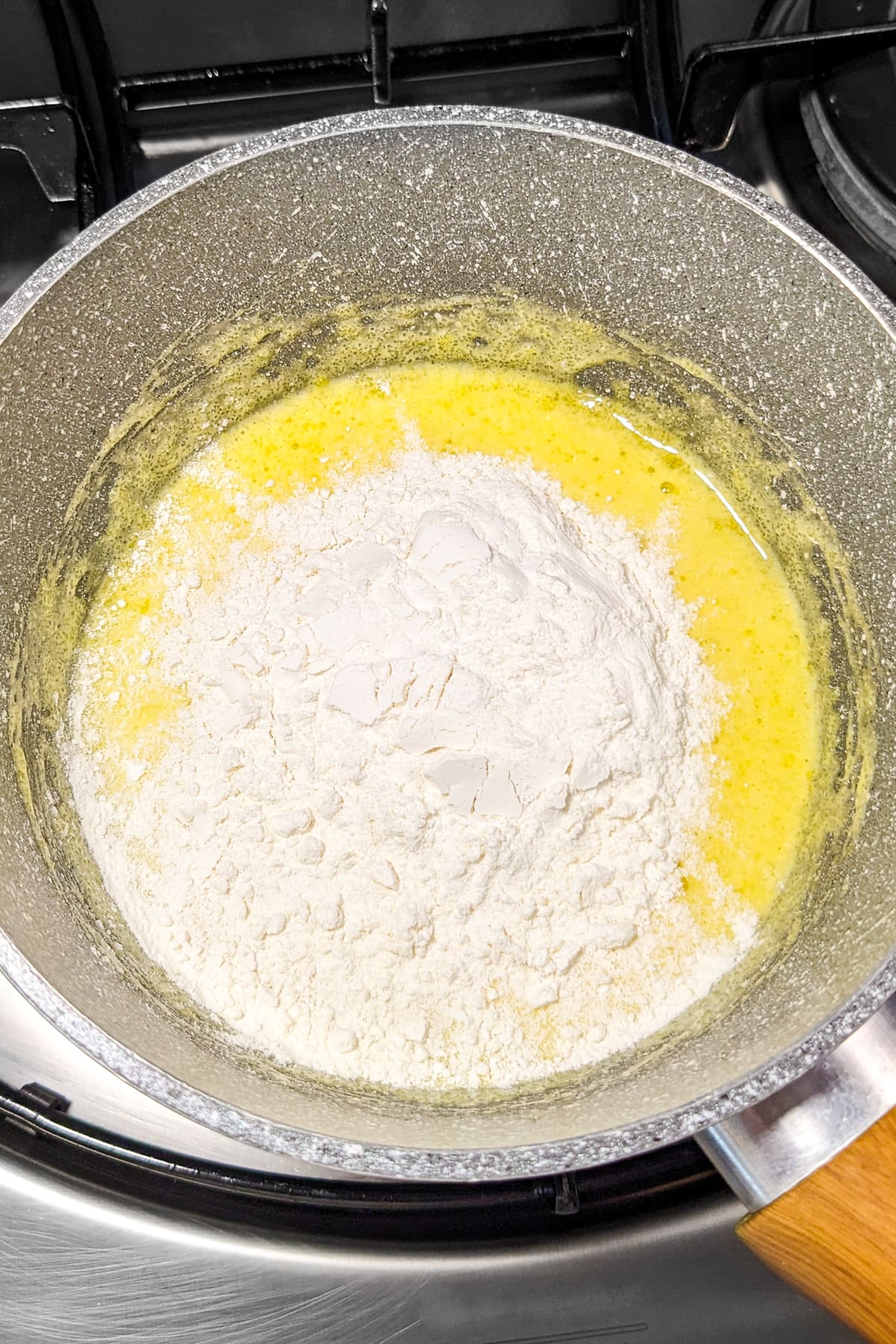 All-purpose-flour over a egg sauce in a saucepan.
