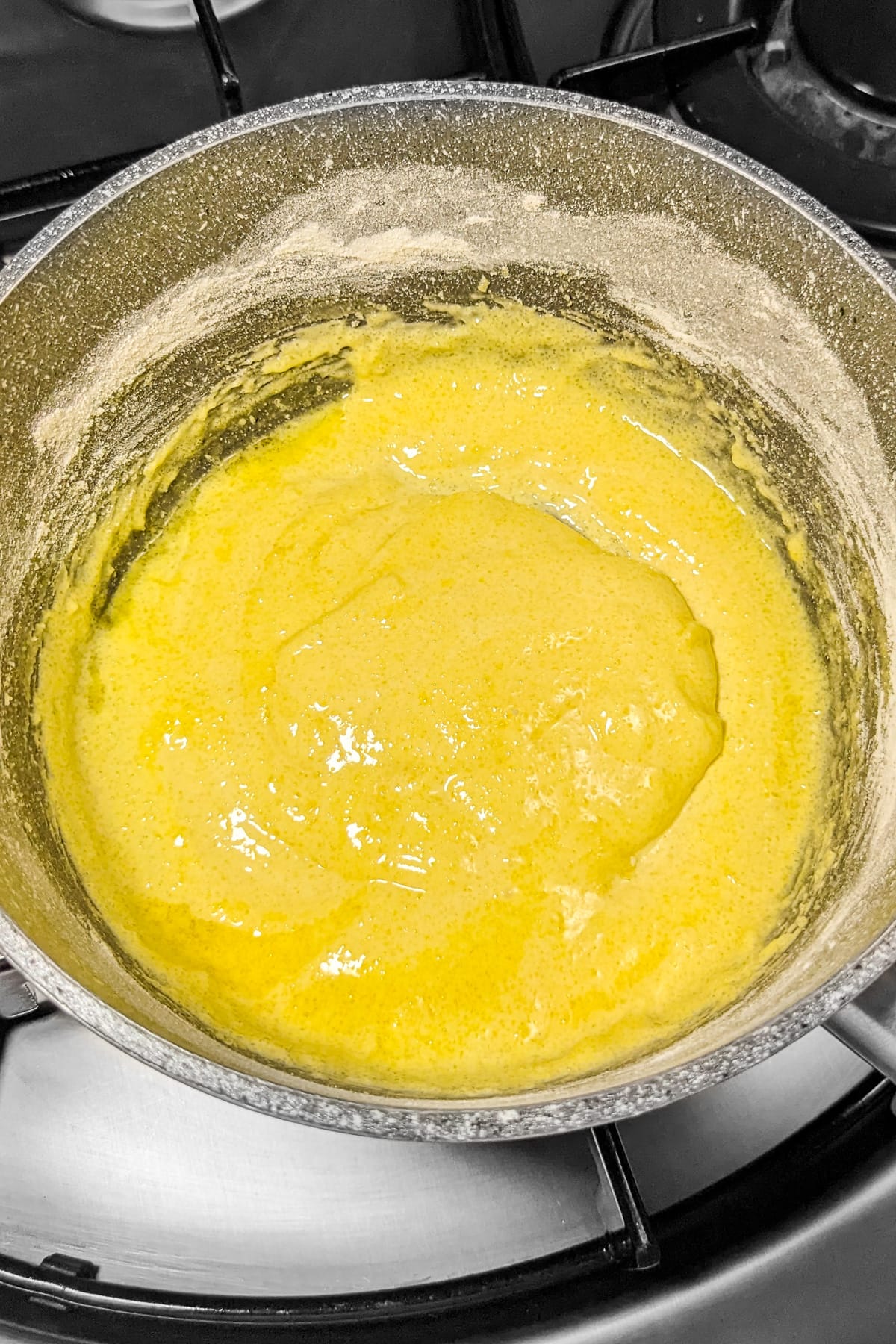Mixed sugar, raw eggs and flour in a sauce pan.