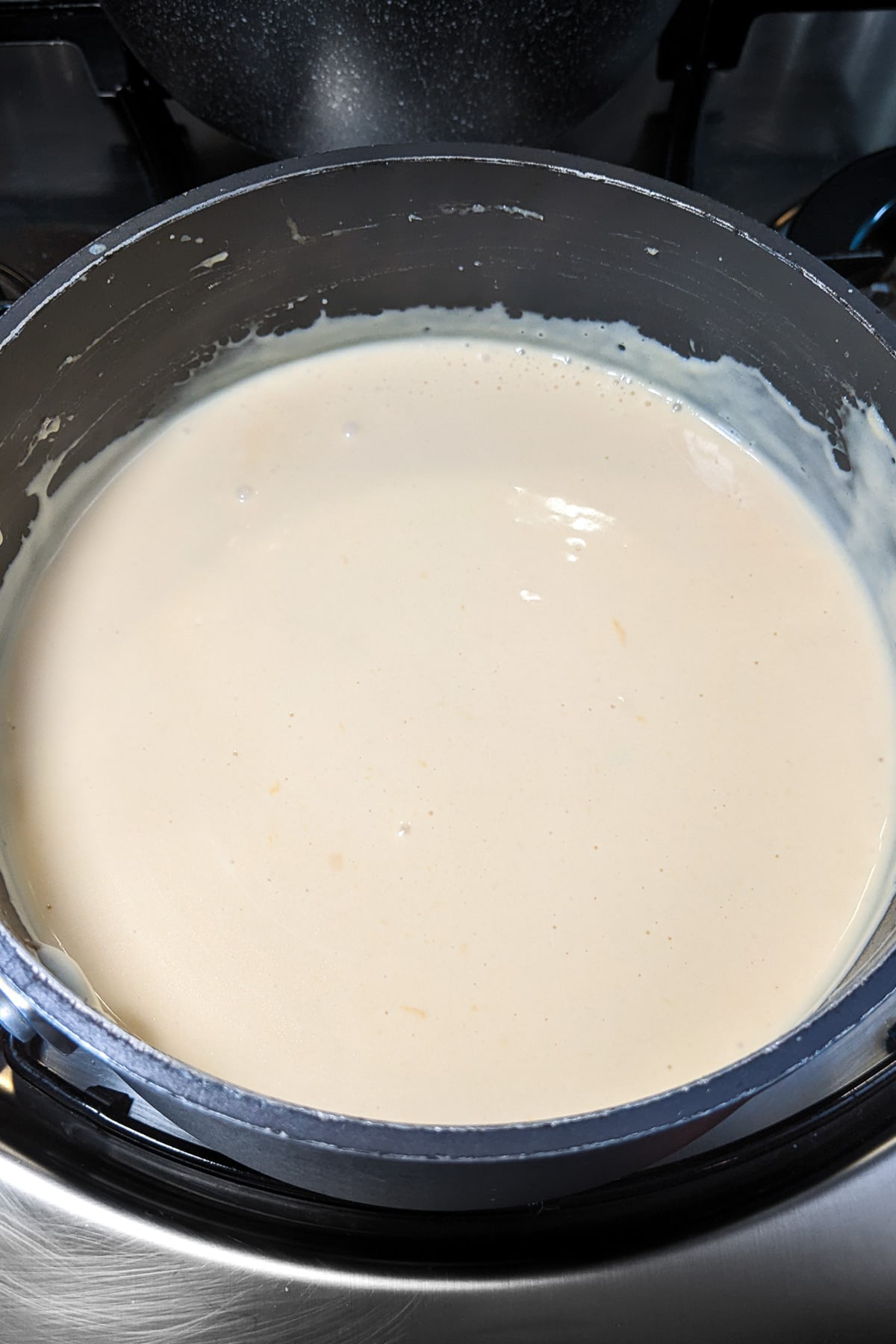 Boiled cream for mac and cheese on the stove.