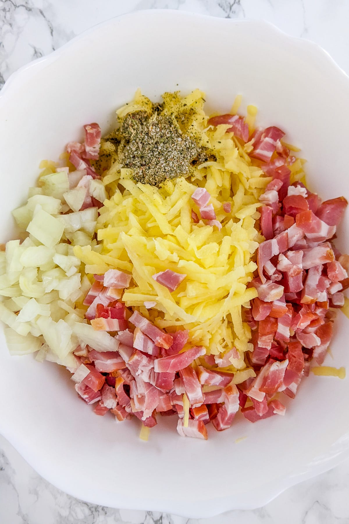 Shredded potatoes, sliced bacon, chopped onions and black pepper.