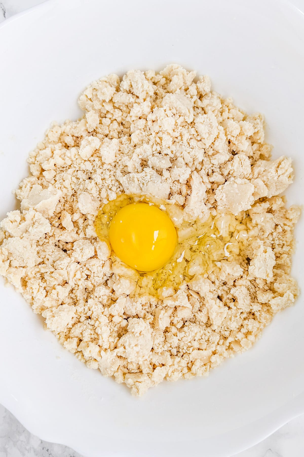 Raw egg over a mix of shortening mixed with flour.