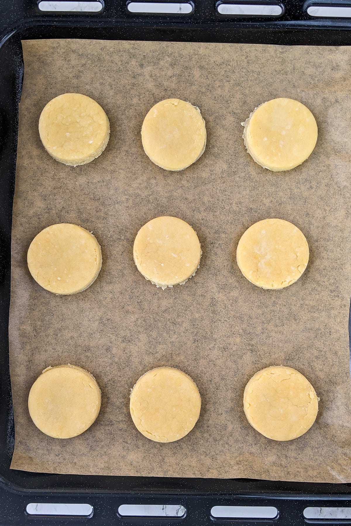 Top view of raw basic biscuits on a traybake.