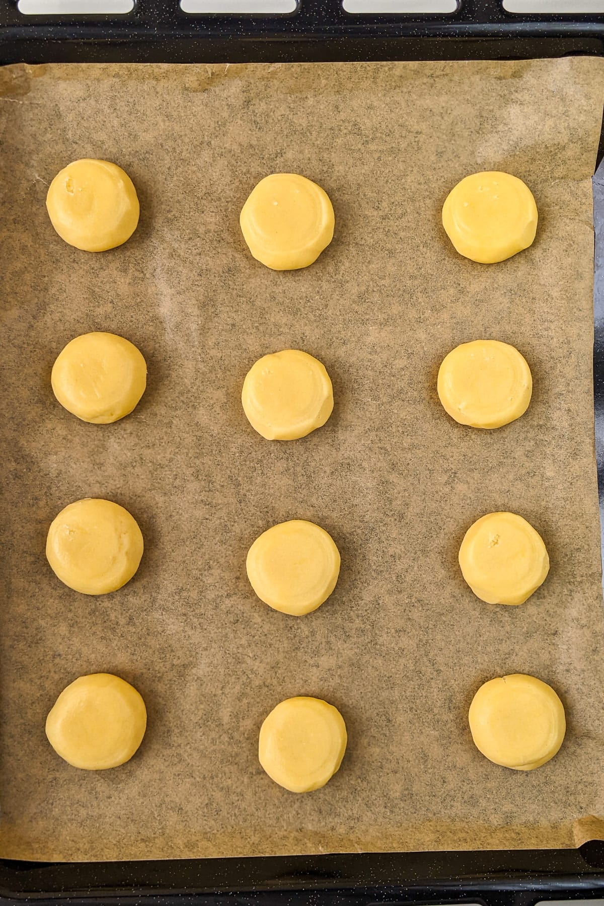 Top view of raw sugar cookies on a traybake.