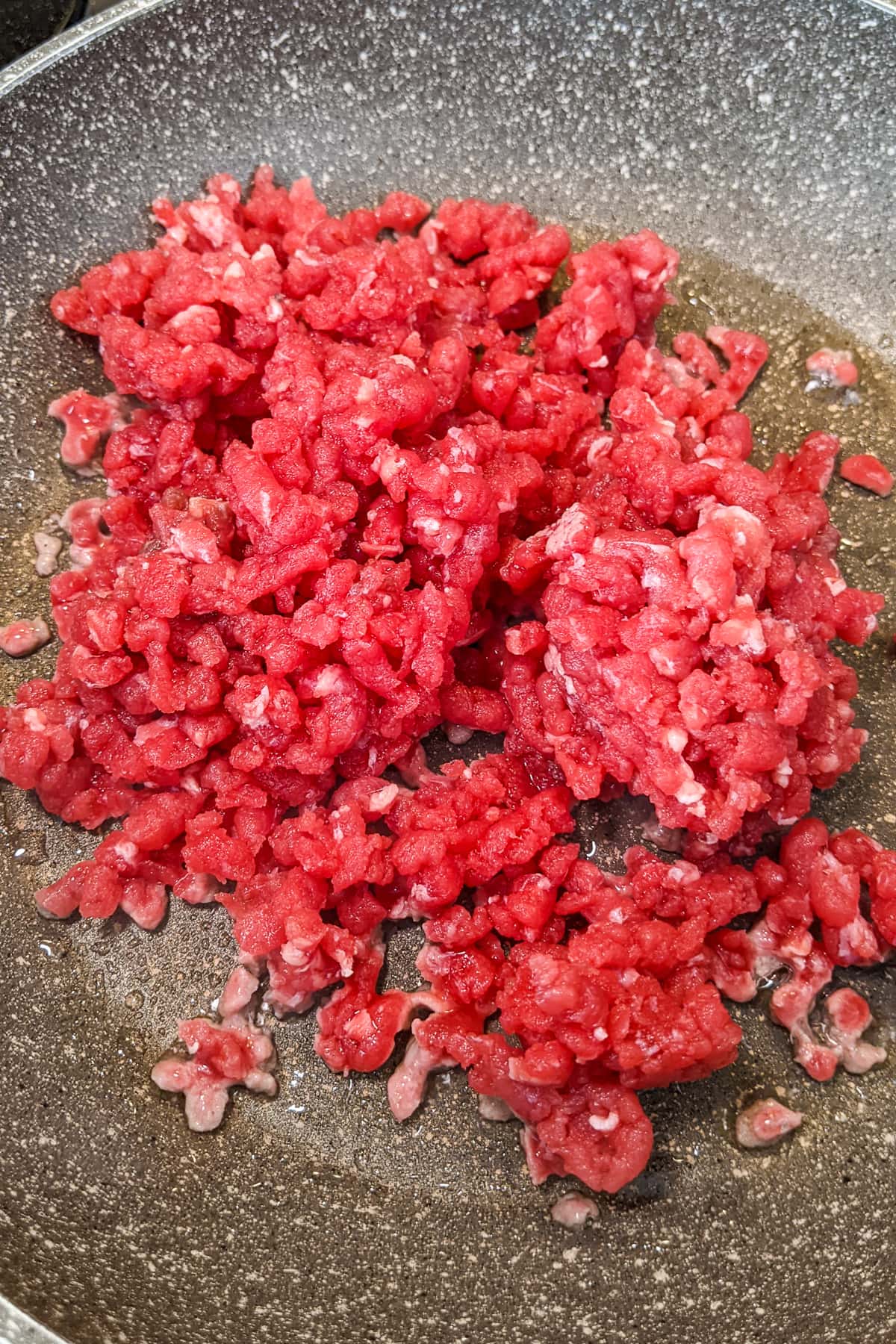 Frying ground beef on a frying pan.