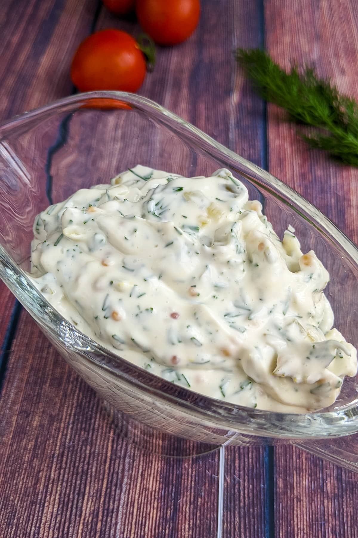 Close view of tartar sauce on a wooden table background.