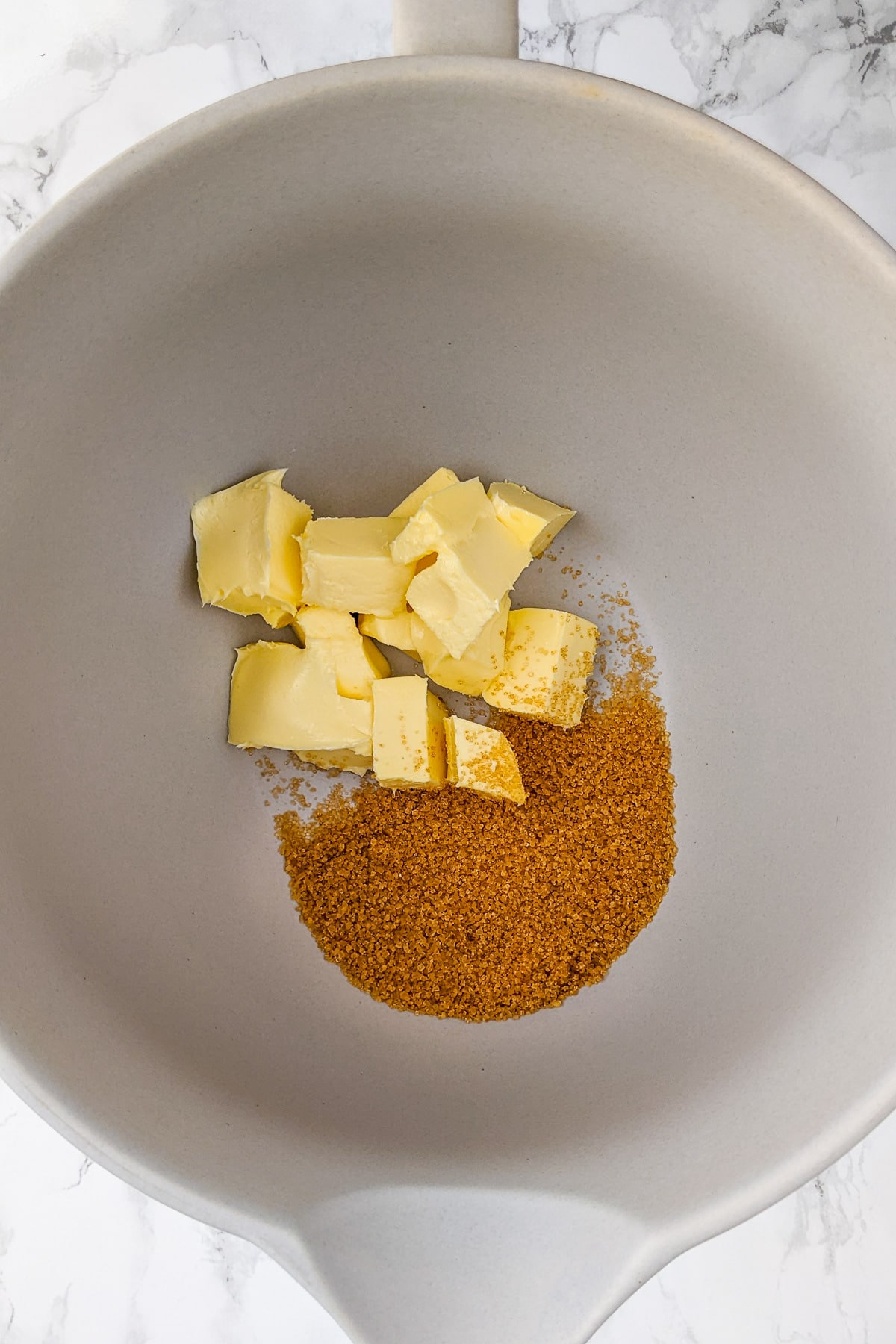 Butter mixing with demerara sugar in a large bowl.