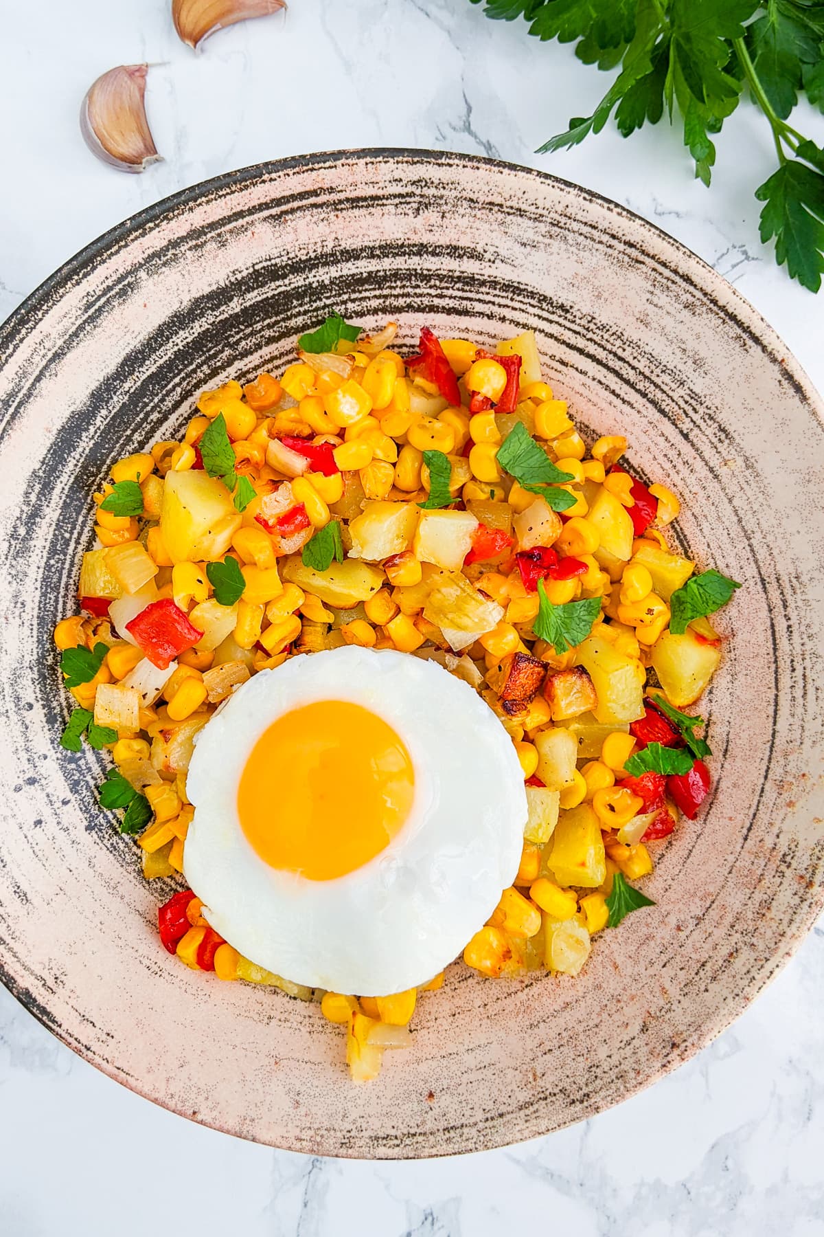 Top view of a vintage plate with corn hash with a fried egg.