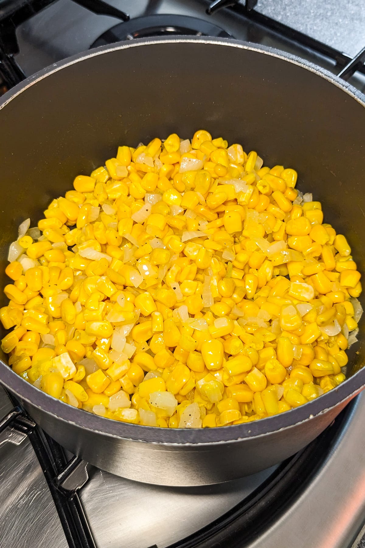 Cooked corn in a saucepan on the stove.