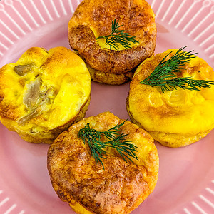 Top view of 4 egg muffins for kids on a pink plate.