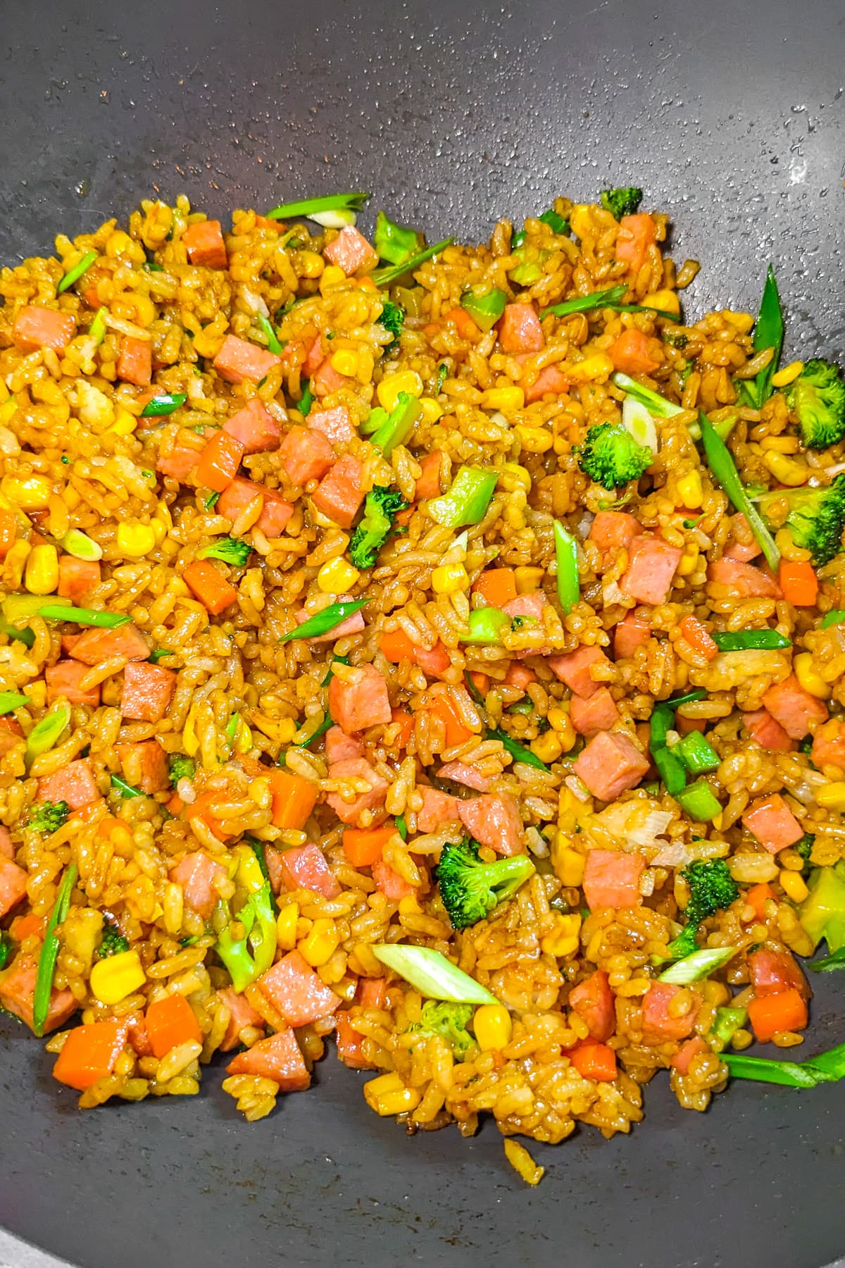 Wok with luncheon meat, corn, broccoli and spring onions.