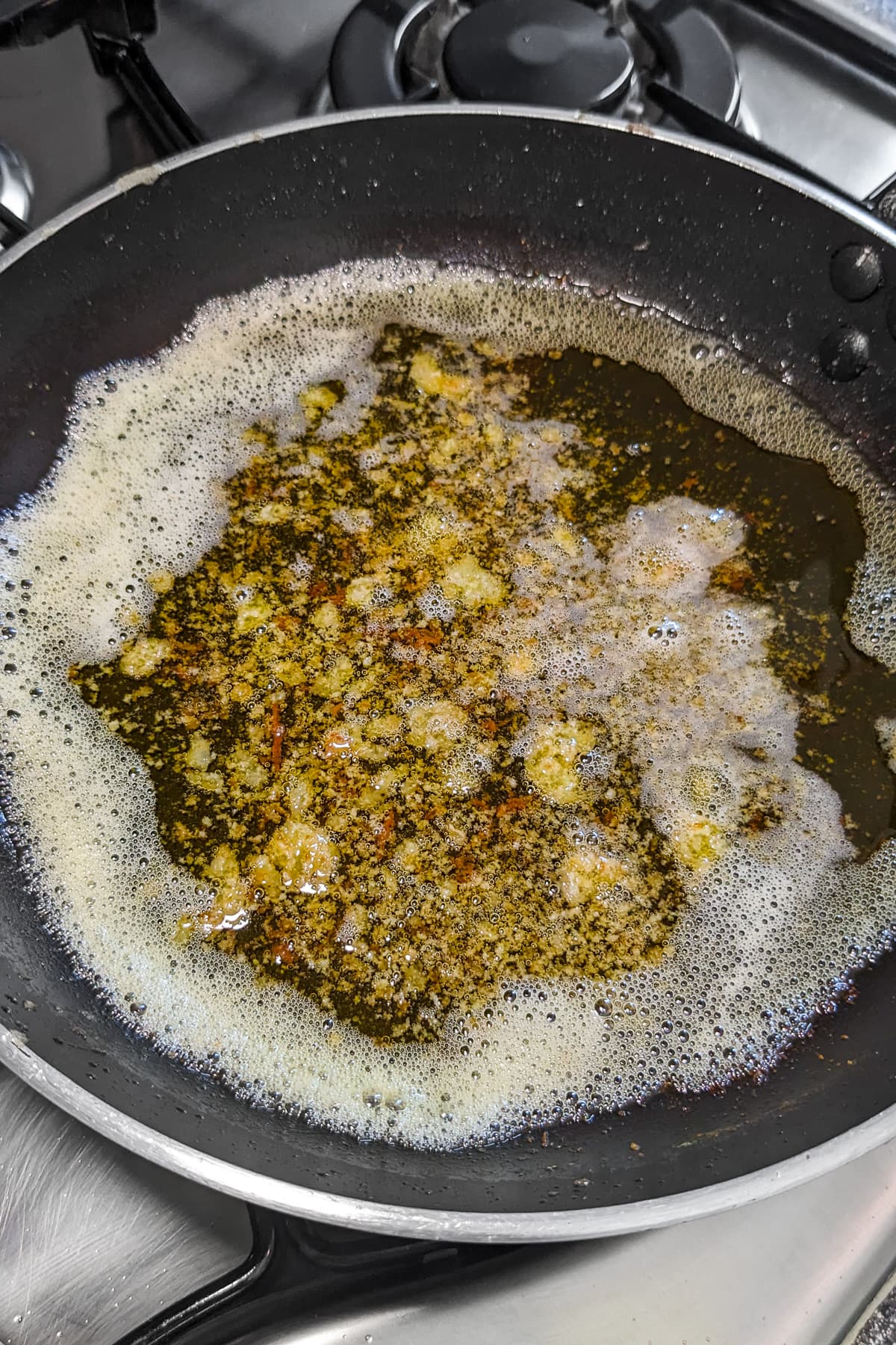 Frying pan with meuniere sauce on the stove.