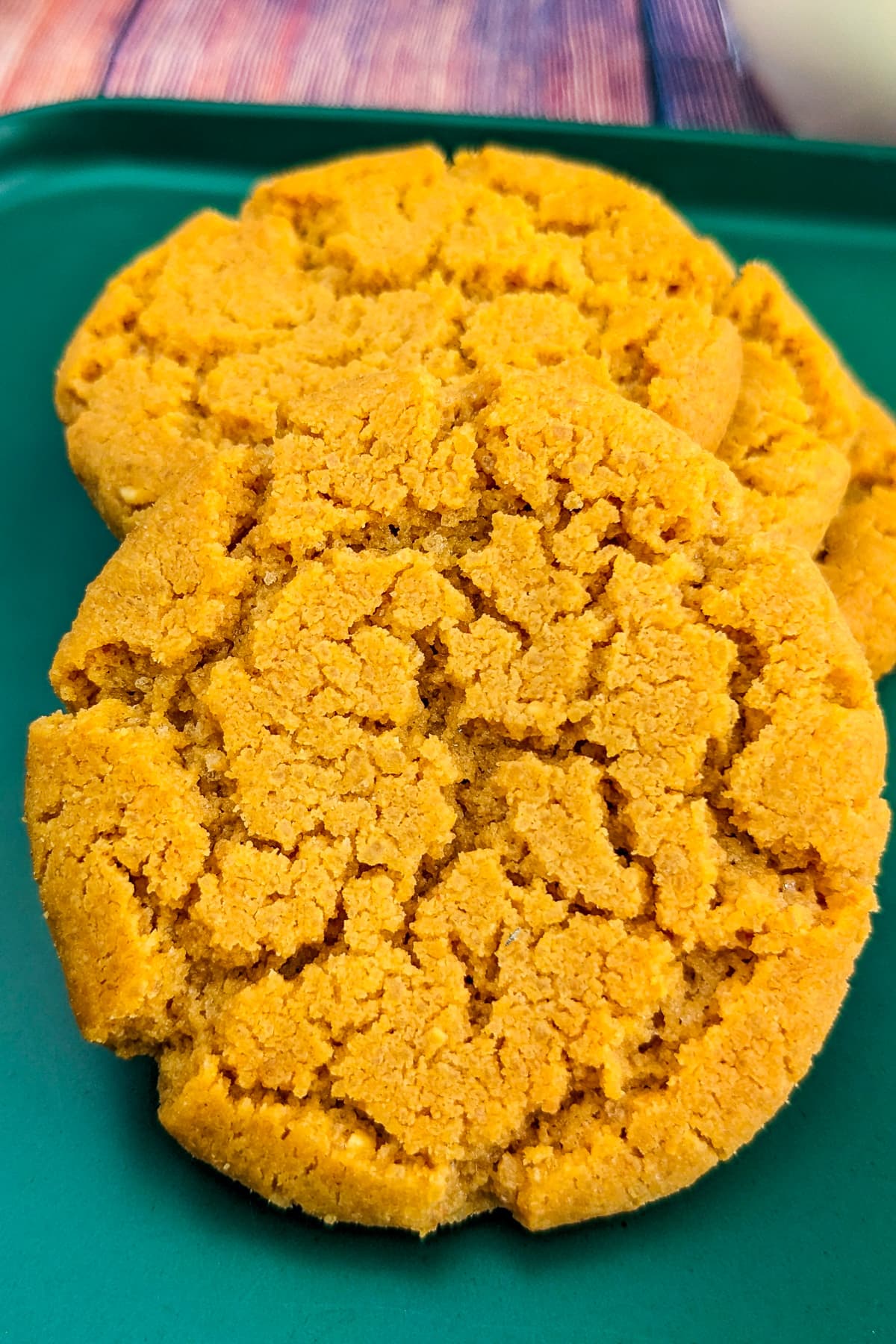 Close look of peanut butter cookies on a green plate.
