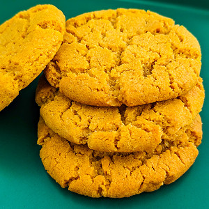 Close look of peanut butter cookies on a green plate.