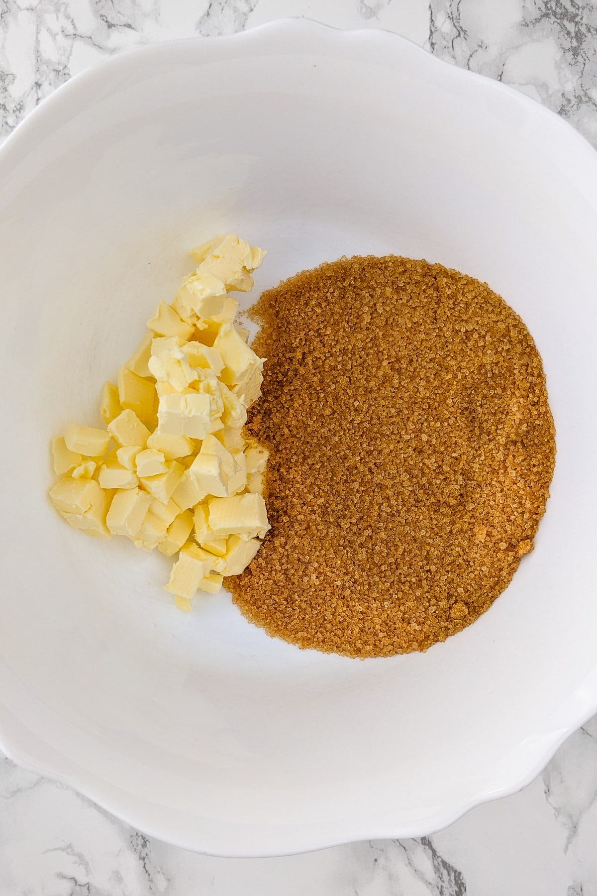 Top view of a plate with butter and brown sugar.