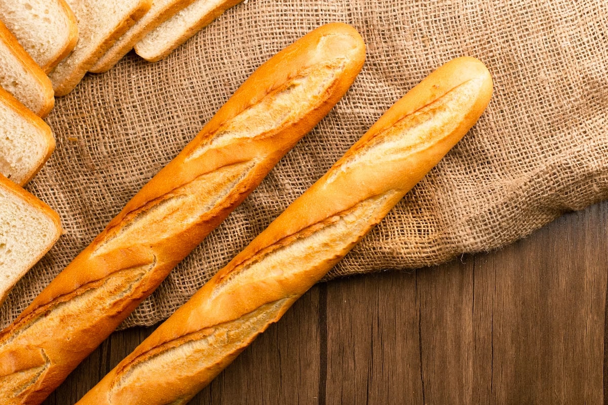 Top view of two French baguettes on a rustic background.